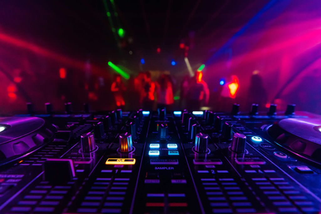 Luminous DJ mixer at a party
