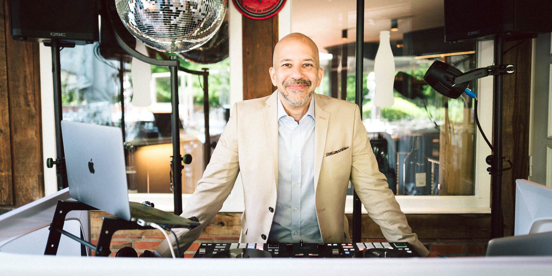 DJ Viru poses behind his DJ booth shortly before an event