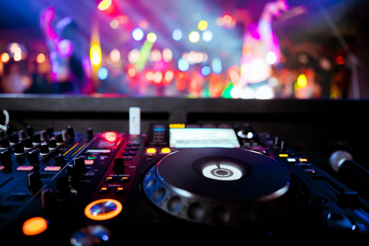 DJ booth with illuminated button at a party