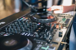 Close-up: Hands of event DJ Markus Rosenbaum mixing on the decks for an after-trade fair event in Cologne.