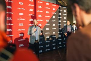 A representative from Life Fitness is speaking to guests at an after-trade fair event in Cologne.