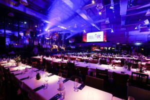 Banquet setting in the festival hall of the soap factory: stylish long table for corporate events combined with high-quality DJ entertainment.