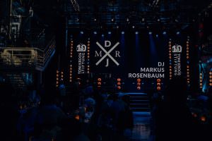 The logo of event DJ Markus Rosenbaum lights up on the big stage during the anniversary of the Toni Kroos Foundation at Lofthaus Düsseldorf.