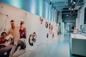 A photo wall at the event in the Lofthaus shows moving moments of Toni Kroos with the children his foundation has supported over the last 10 years.