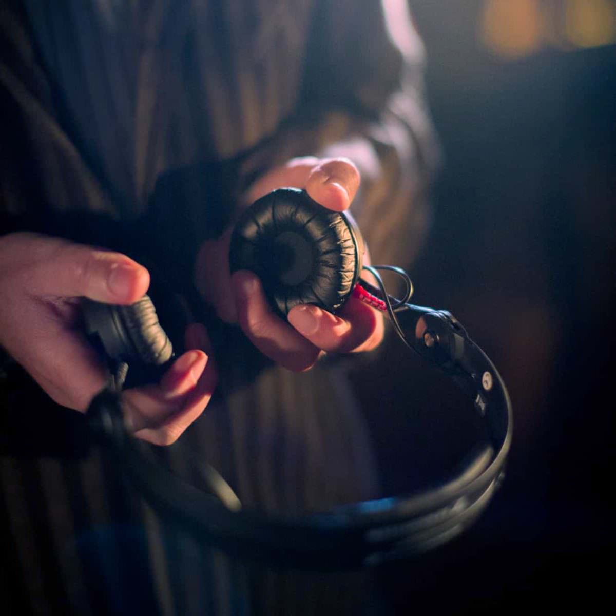 DJ Markus Rosenbaum holds his headphones in his hands.